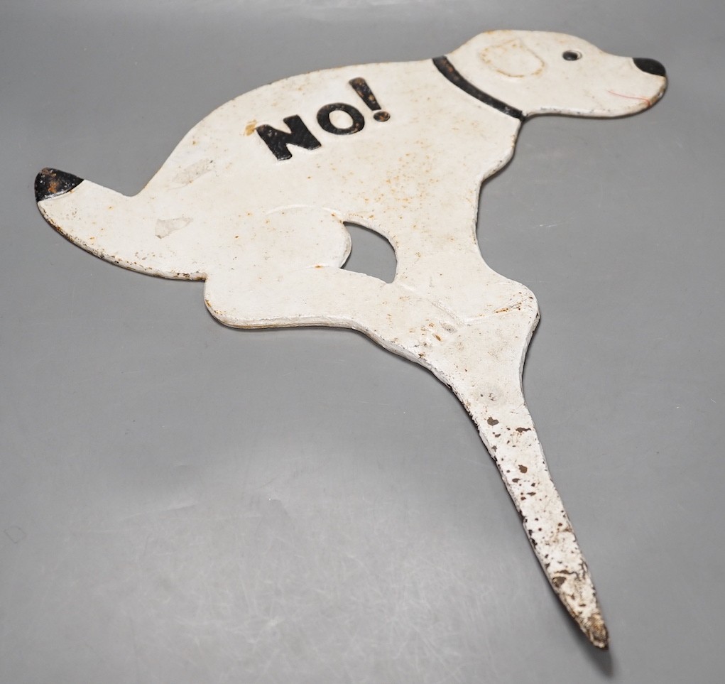 A 1950's novelty painted cast iron sign, in the form of a squatting dog